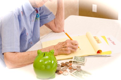 A senior woman managing finances and dealing with debt