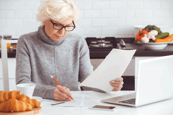 senior woman checking on the assisted living costs
