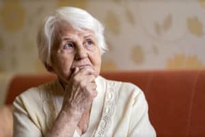 senior woman wondering if it's safe to move to an assisted living during covid-19